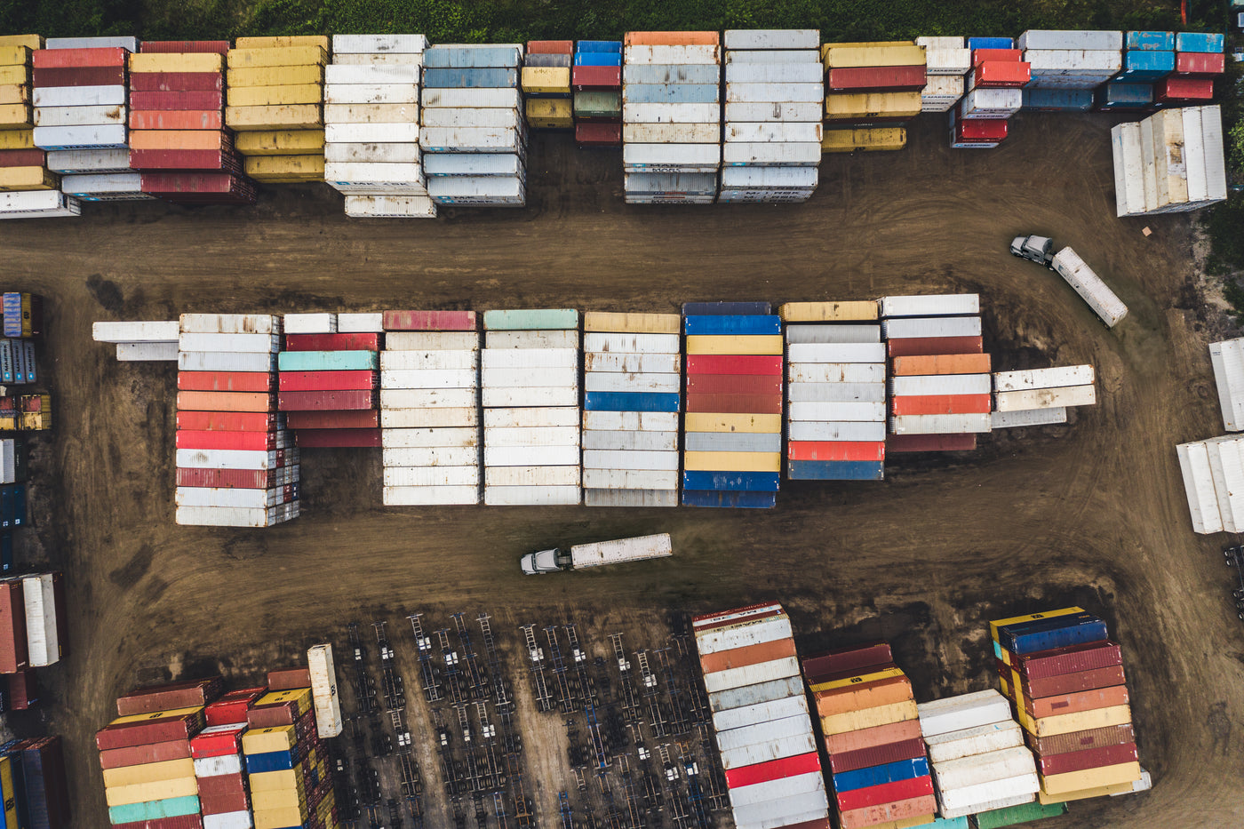 Aerial view of a container storage yard with trucks