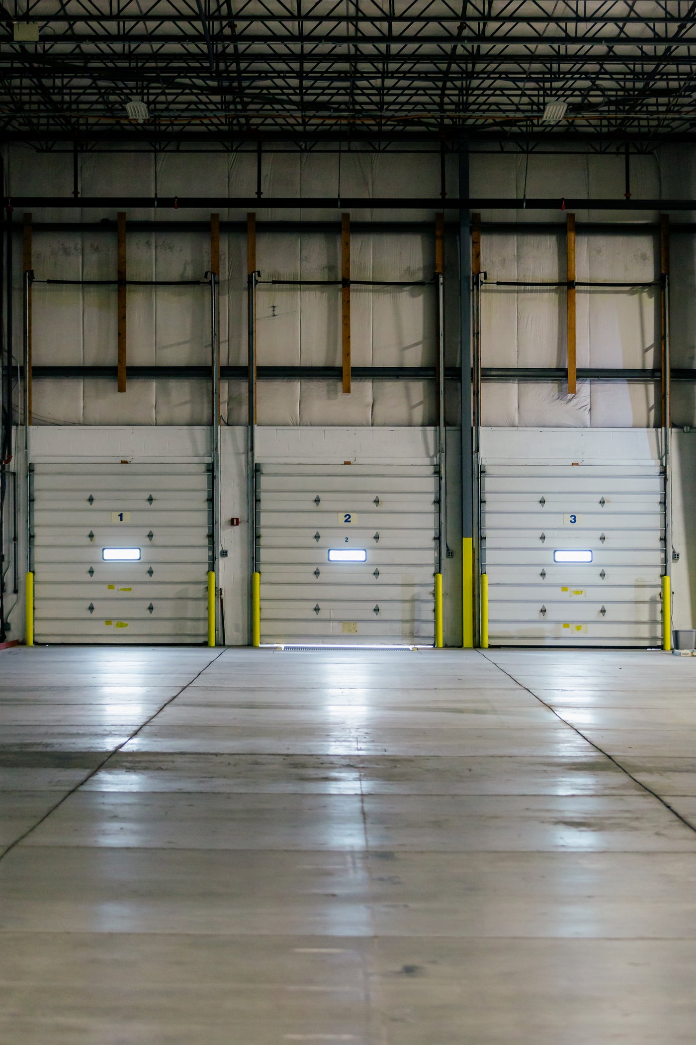 Empty warehouse interior with numbered dock doors