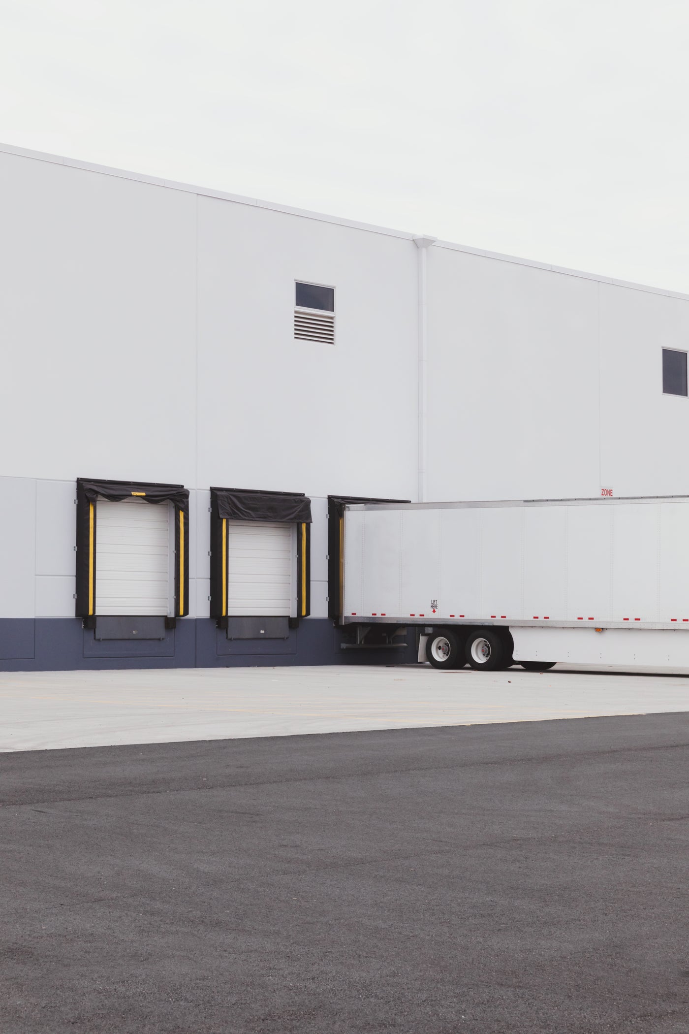 Semi trailer backed into a dock-high door at a warehouse